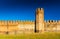 Brick wall with tower. Medieval Italian walled town