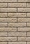 Brick wall with uneven rough beige brick. Decorative wall decoration with brick stone, texture background backdrop. Wall of smooth