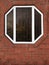 brick wall with an unusually shaped window. Octagonal window frame.
