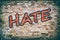 Brick wall with word hate graffiti.