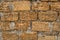 Brick wall of yellow shell rock. Closeup of shellstone texture. Background wall with shell rock. Old wall. Texture limestone