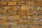 Brick wall of yellow shell rock. Closeup of shellstone texture. Background wall with shell rock. Old wall. Texture limestone