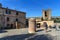 Brick water pump on square in Monteriggioni. Tuscany. Italy