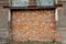 Bricked up door or gate frame. Condemned neglected deserted industrial building with red bricks wall. Concept of final or end of