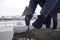 A bricklayer aligns bricks in cement, makes a concrete wall.