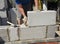 Bricklayer builder laying autoclaved aerated concrete blocks, aac for new house wall.  Autoclaved aerated concrete blocks walling