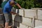 Bricklayer builder laying autoclaved aerated concrete blocks for house wall