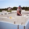 Bricklayer building wall from aerated concrete blocks