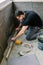 Bricklayer checking floor with a level