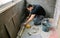 Bricklayer checking floor with a level