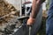 Bricklayer in glove spreading concrete to build a wall on construction site