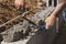 Bricklayer in glove spreading concrete to build a wall on construction site