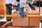 Bricklayer industrial worker installing brick masonry on exterior wall using level and rubber hammer