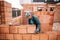 Bricklayer industrial worker installing new bricks. masonry on exterior wall