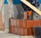 Bricklayer installing brick masonry on interior wall