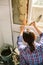 Bricklayer laying tile on the wall with spatula