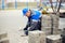 Bricklayer lays paving slabs outside. Working man performs landscaping. Builder lays out sidewalk with stone blocks.