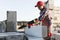 Bricklayer man is sawing autoclaved concrete blocks