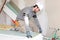 Bricklayer measuring plasterboard