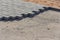 Bricklayer places concrete paving stone blocks for building up a Sidewalk pavement