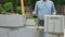 Bricklayer putting down another row of bricks in site