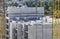 Bricklayer workers in safety orange vests and hard hats make walls of white silicate bricks on a construction site of a big