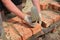 Bricklayers hands with in masonry trowel bricklaying  new house wall on foundation