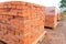 The bricks are stacked on wooden pallets and prepared for sale. Clay brick is an ecological building material.