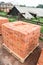 The bricks are stacked on wooden pallets and prepared for sale. Clay brick is an ecological building material.