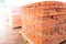 The bricks are stacked on wooden pallets and prepared for sale. Clay brick is an ecological building material.