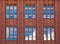 Brickwall facade with reflections of blue sky