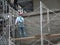 Brickwall plastered by construction workers using cement plaster.