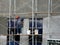 Brickwall plastered by construction workers using cement plaster.