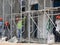 Brickwall plastered by construction workers using cement plaster.