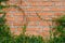 Brickwall texture frame with foliage. Old rustic red block brickwall background
