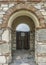 Brickwork, arch and wood door.