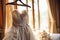Bridal anticipation Wedding dress adorns a curtain rail, awaiting celebration
