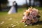 Bridal beauty Bouquet laid on grass, a married couple behind