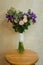 Bridal bouquet of bride with purple flowers lies on a chair