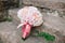 Bridal bouquet of pink roses and hydrangea, with pink ribbons down on the stone steps and wedding rings near it