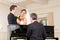 Bridal couple in front of a piano