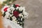 bridal holding fresh bouquet with roses and leaves