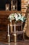 Bridal morning: burning candles on bottles-candlesticks and an arrangement with a fresh flowers in a vase.