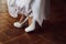 Bridal wedding shoes. Beautiful white shoes on high heels. Women legs