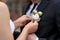 Bride adjusting groom\'s boutonniere