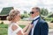 The bride adjusts the groom`s tie outdoors