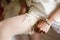 Bride adjusts a lace garter on a stocking