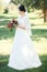 Bride on a background of trees, Fine portrait, full-length.