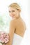 Bride In Backless Wedding Dress With Flower Bouquet Smiling