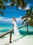 Bride on the beach. Stylish female model in elegant long gown dress on the Maldives beach. Elegance. Bride on Maldives. Bridal